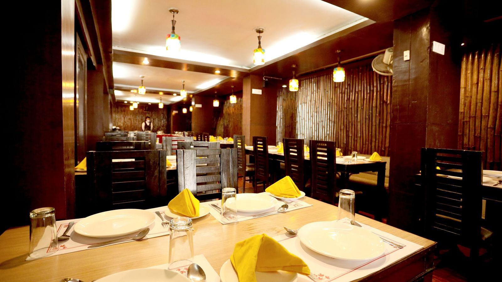 Image of a table with crockery and napkins arranged on the table at Amara Hill Queen, Mussoorie.